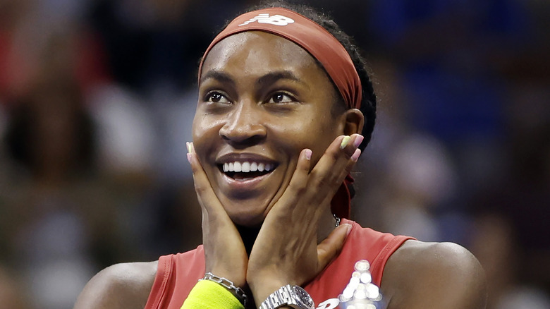 Coco Gauff smiling with her hands on her face in excitement