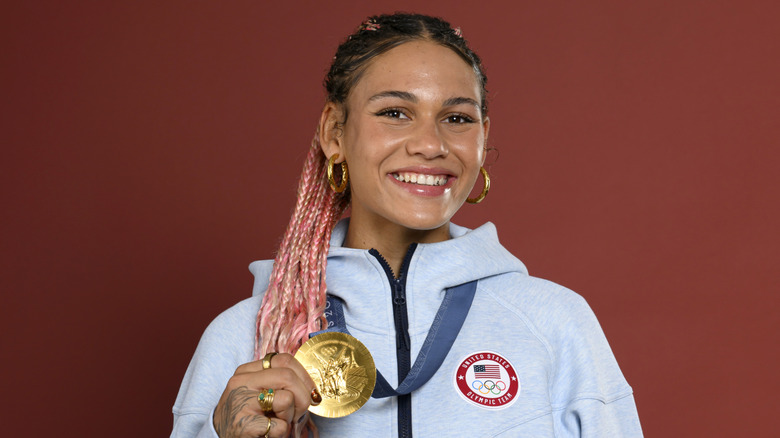 Trinity Rodman smiling with her Olympic gold medal on the set of the Today show.