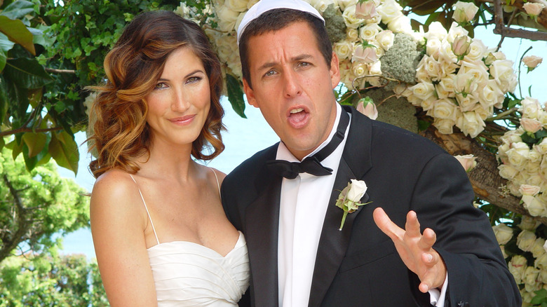 Jackie Sandler and Adam Sandler posing together at their wedding