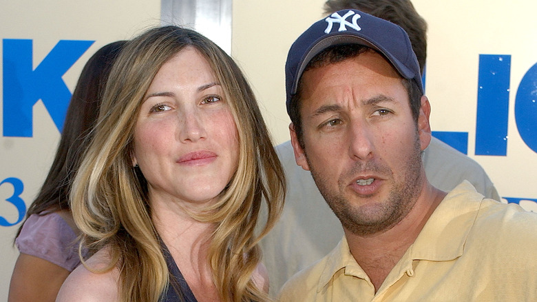 Jackie Sandler smiling, Adam Sandler frowning