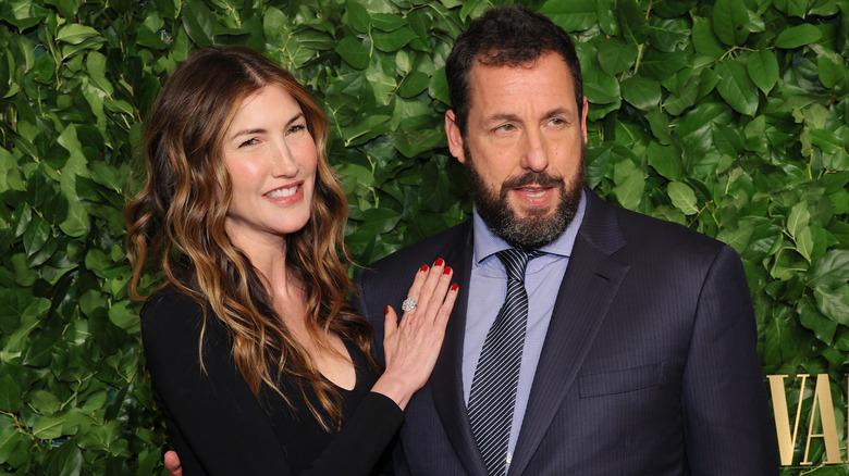 Jackie Sandler placing hand on Adam Sandler's chest