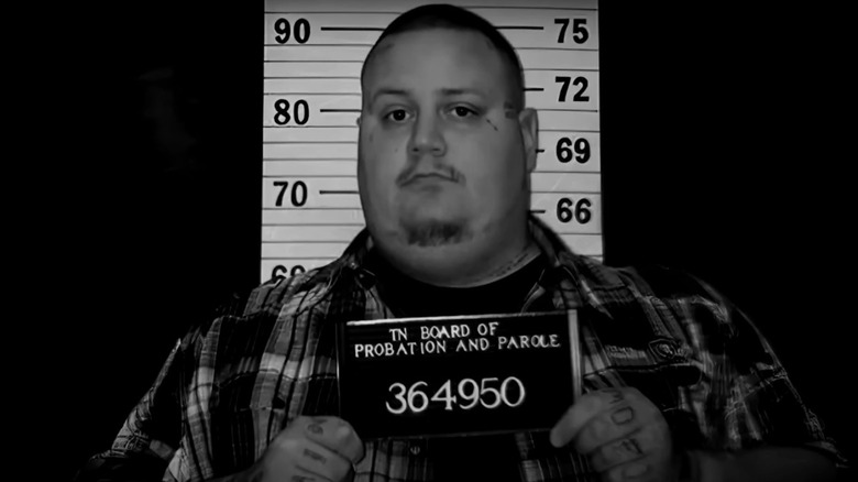 Jelly Roll posing for a mug shot