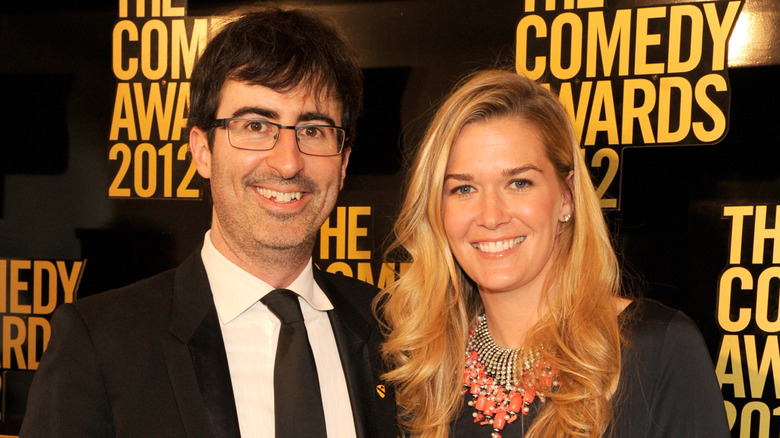 John Oliver posing and smiling with wife, Kate Norley