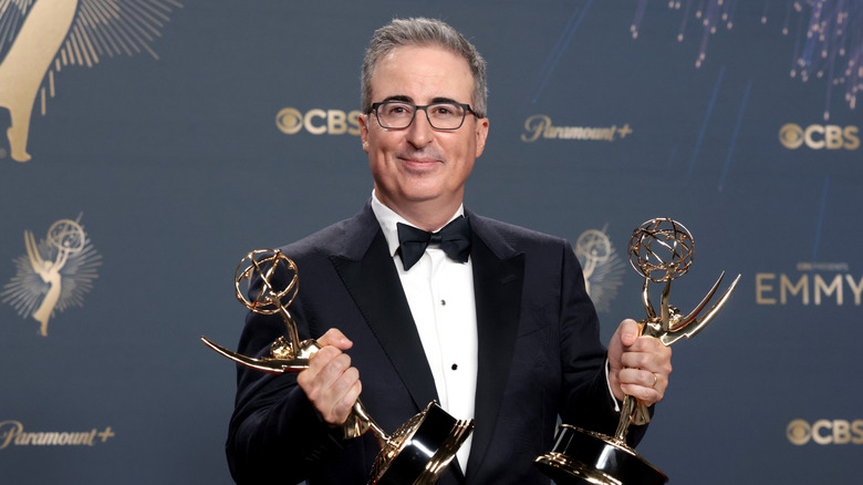 John Oliver holding two Emmys