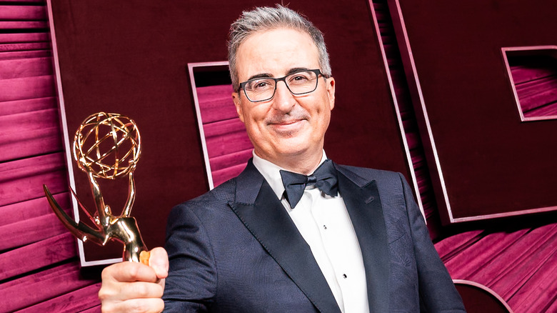 John Oliver holding an Emmy