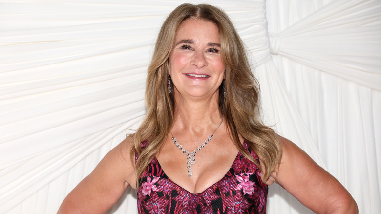 Melinda Gates smiles with her hands on her hips.
