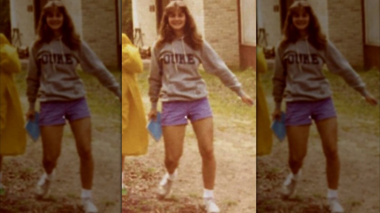 Melinda Gates, wearing a Duke University sweatshirt, walks while swaying one hand.