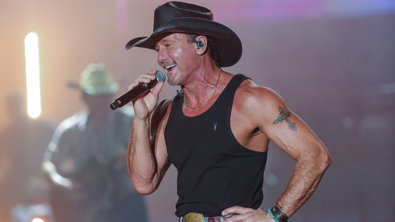 Tim McGraw wearing a tank top in concert