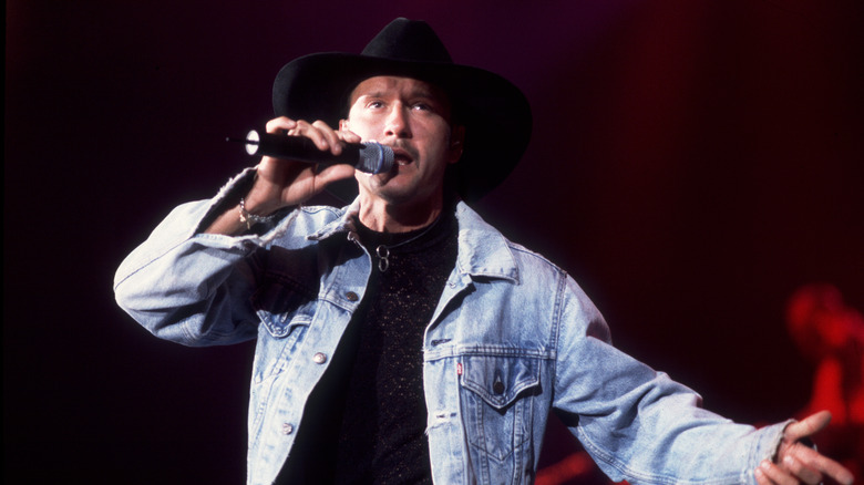 Tim McGraw wearing a denim jacket during concert