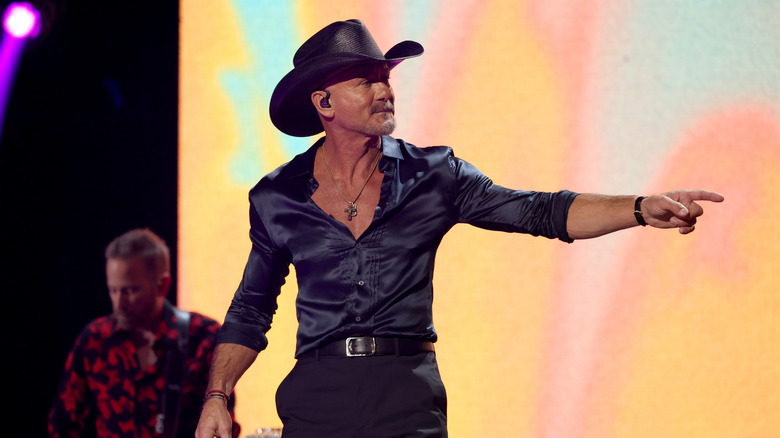 Tim McGraw onstage in front of a yellow background