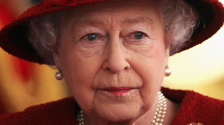 Queen Elizabeth purses her lips during a photo call