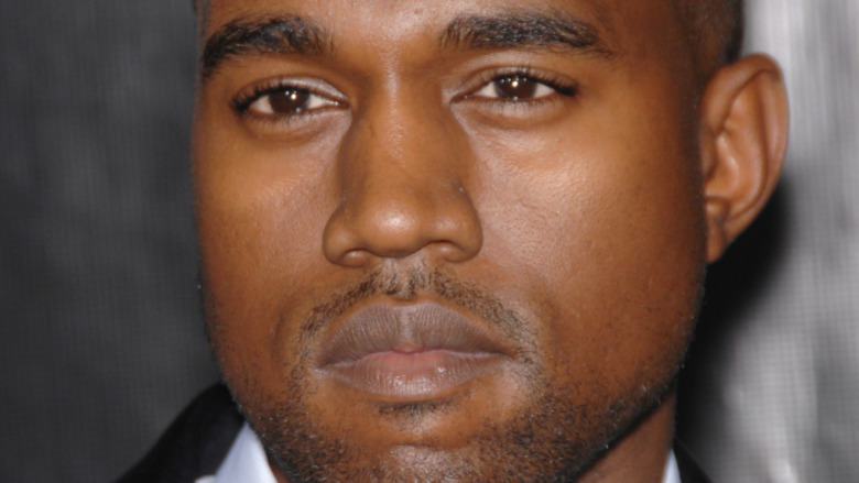 Kanye West with a neutral expression