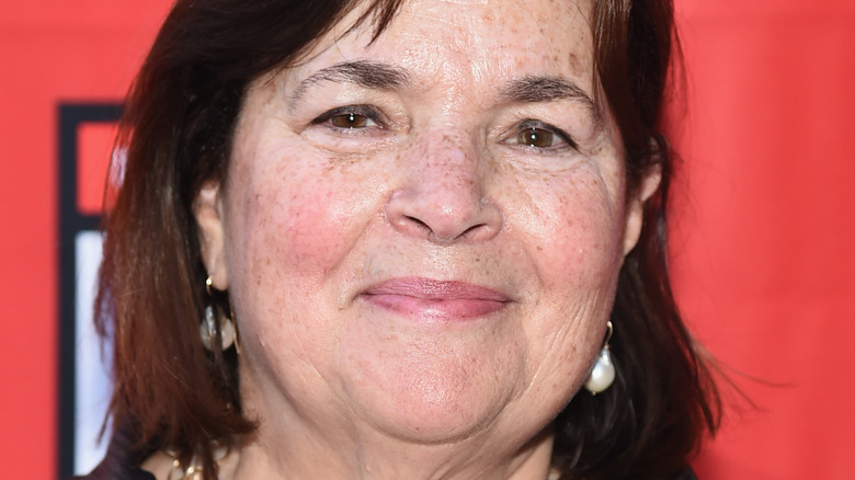Ina Garten poses in a dark outfit.