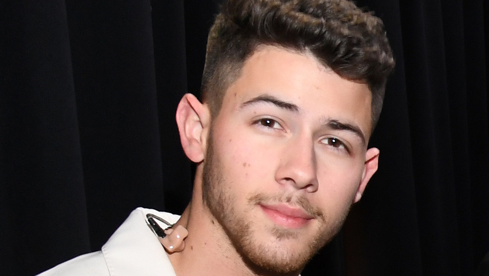 Nick Jonas posing with his head tilted to his left side