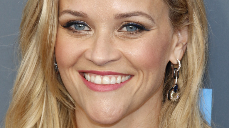 Reese Witherspoon smiles in stylish earrings
