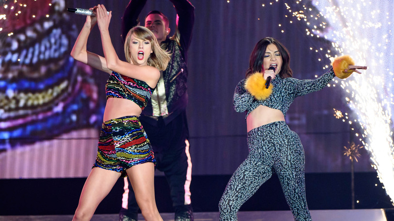 Taylor Swift and Charlie XCX performing on stage together.