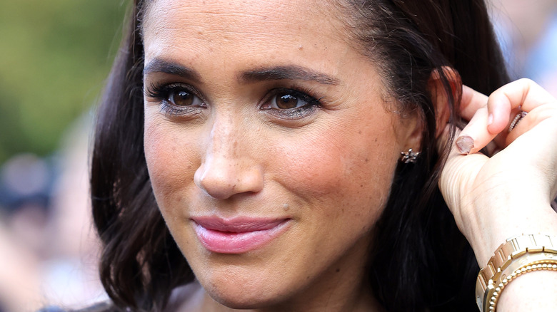 Meghan Markle tucking hair behind ear