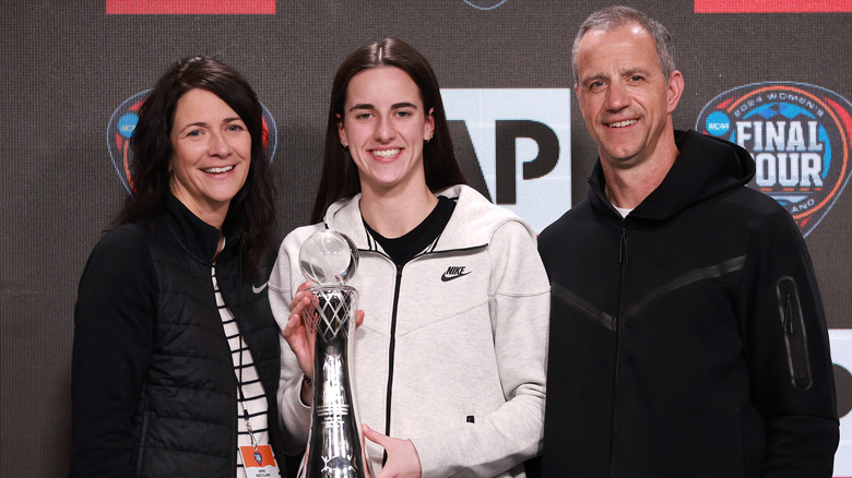 Caitlin Clark posing with parents