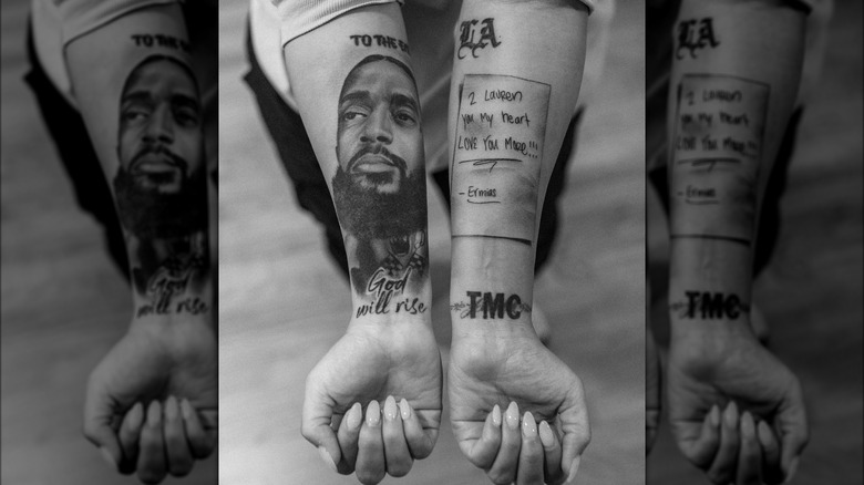 Lauren London displaying the arm tattoos that honor Nipsey Hussle