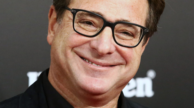 Bob Saget smiling cocked head