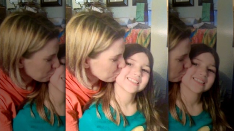 Amanda Brumfield kisses her daughter