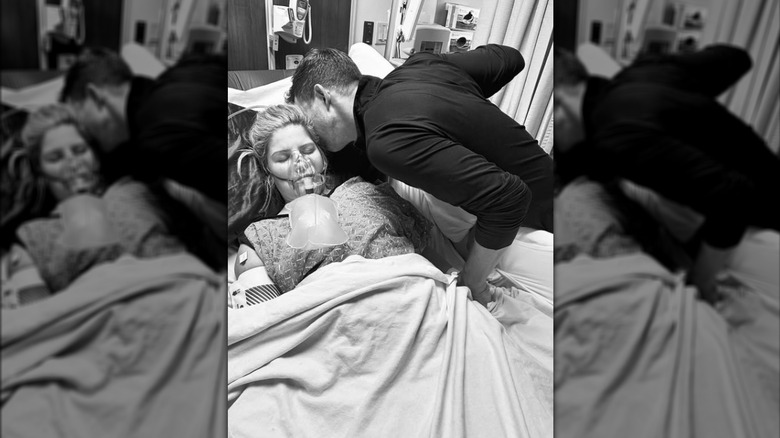 Chad Paine kissing Erin Bates while she sleeps in a hospital bed.