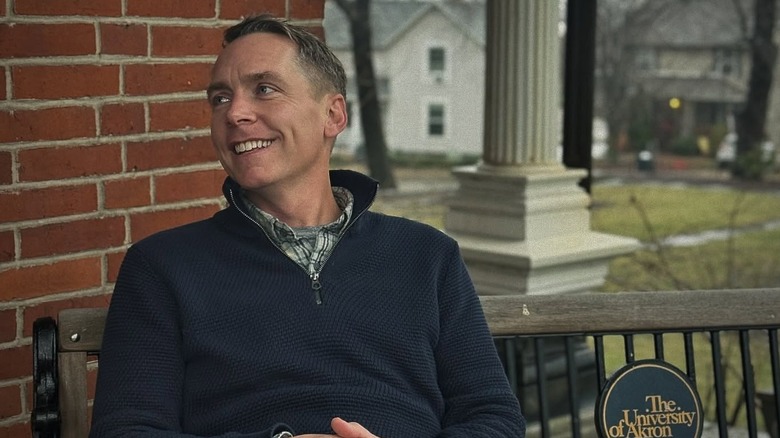 Clint Harp smiling on bench