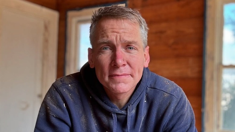 Clint Harp poses inside a home