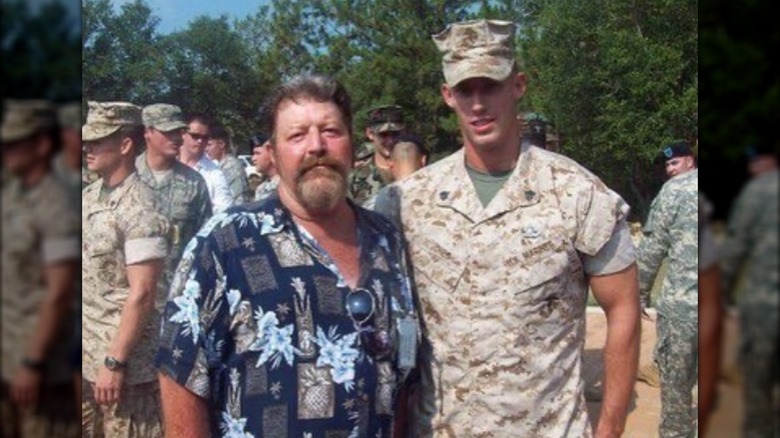Johnny Joey Jones posing with his dad in his Marines uniform.