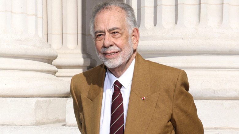 Francis Ford Coppola smiling in a brown jacket