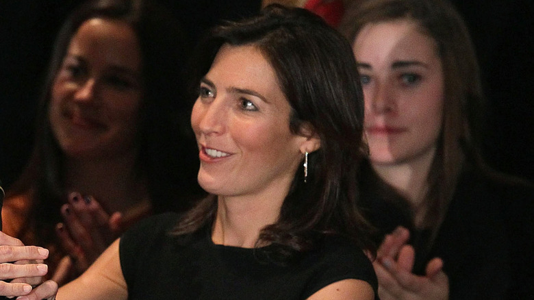 Hallie Biden smiling on stage in black dress