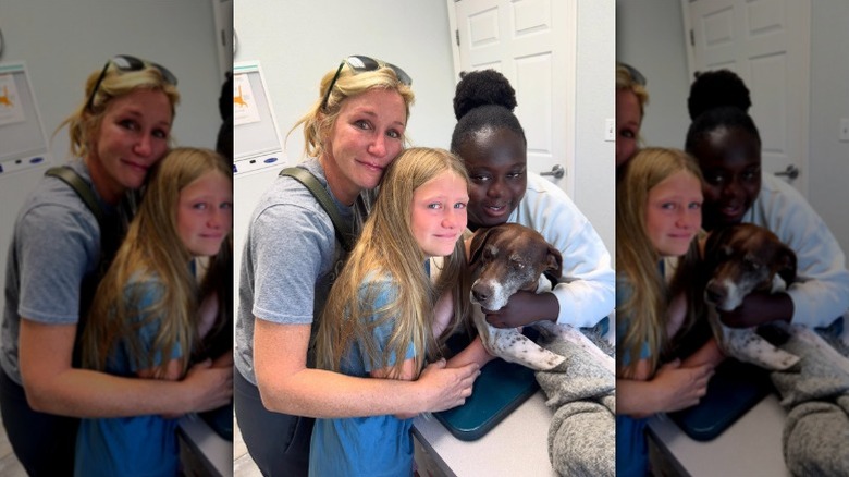 Jenny Marrs and her daughters hug Dolly at the vet