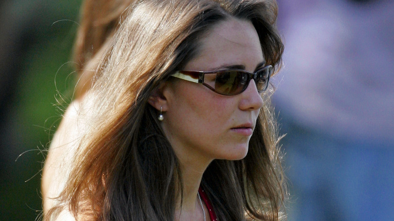 Kate Middleton wearing sunglasses and walking by