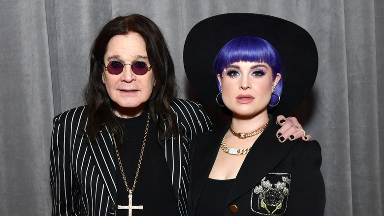 Ozzy Osbourne and Kelly Osbourne posing for a photo
