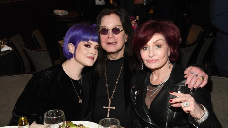 Kelly Osbourne poses for a photo with her parents