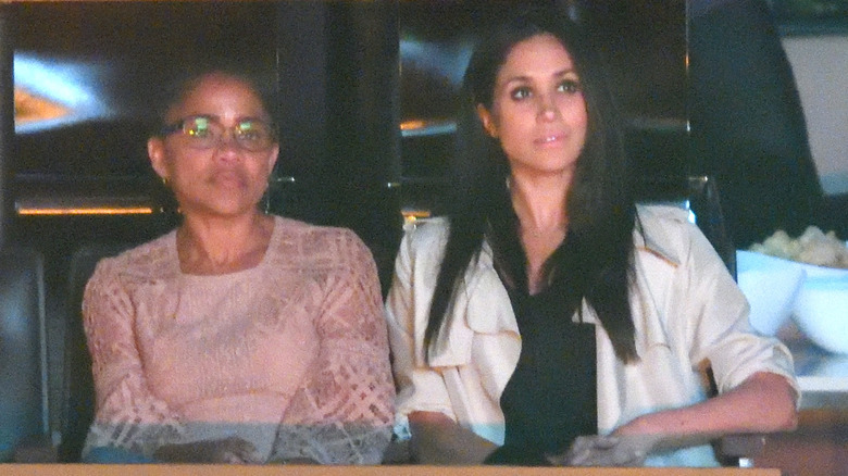Doria Ragland sits next to Meghan Markle in 2017