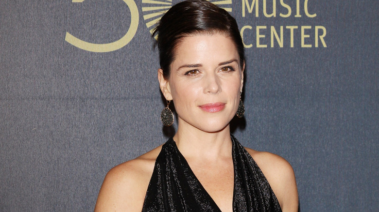 Neve Campbell wearing a black gown on the red carpet
