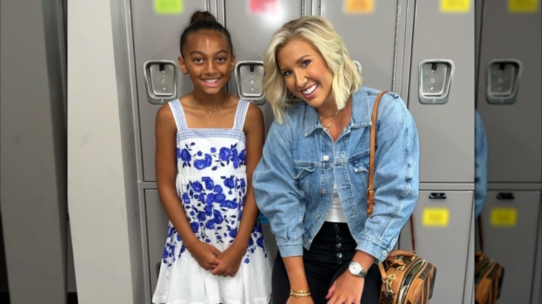 Savannah Chrisley leans toward Chloe Chrisley as the pair sport wide smiles.