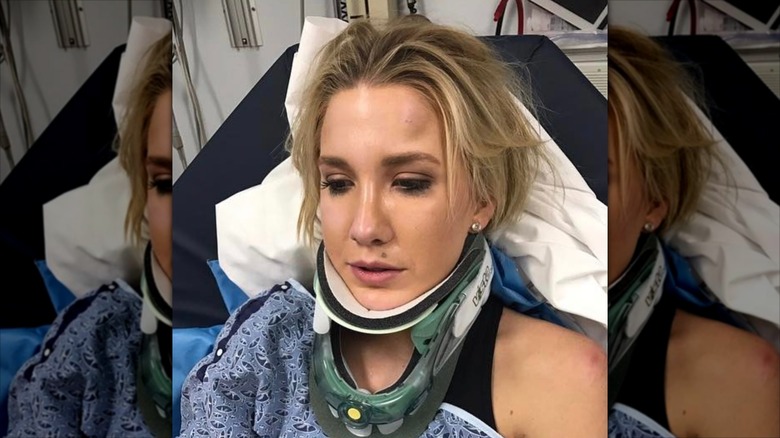 Savannah Chrisley lies on a hospital bed and looks to the side while wearing a neck brace.