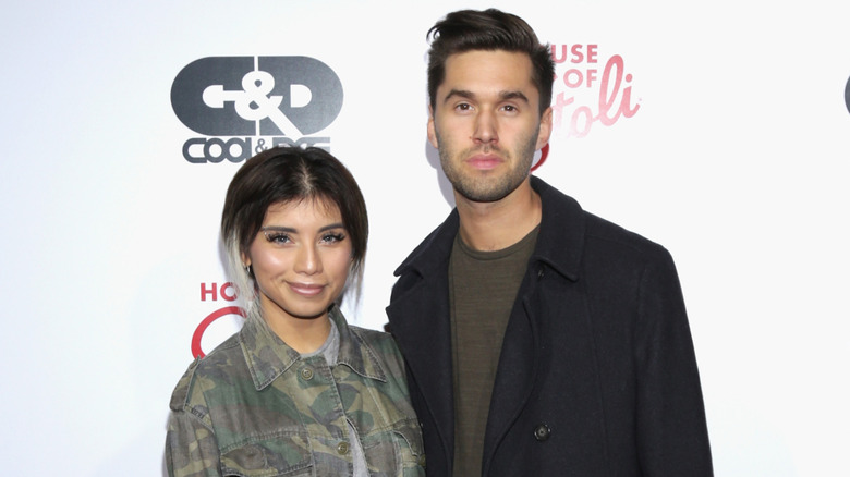 Kirstin Maldonado wearing a camo jacket and posing beside Jeremy Michael Lewis