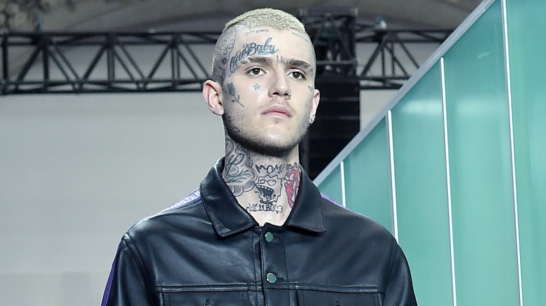 Lil Peep at a fashion show wearing black leather outfit