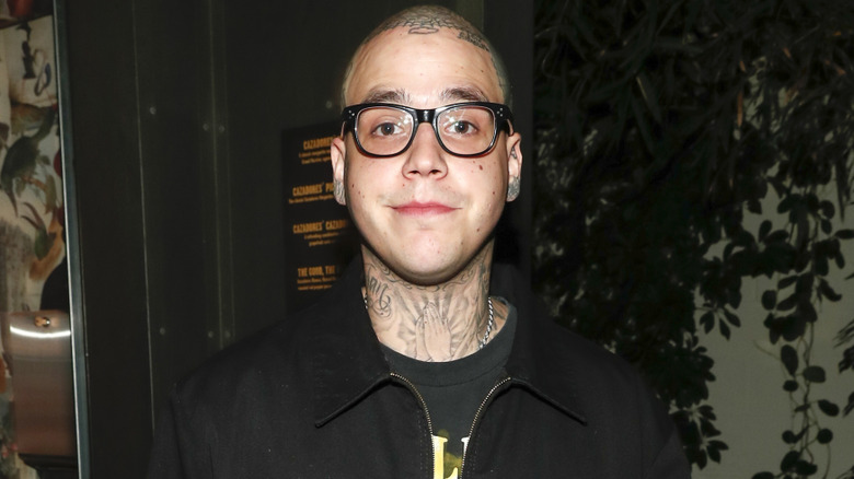 Richard Hilfiger posing for cameras wearing glasses and sporting a shaved head