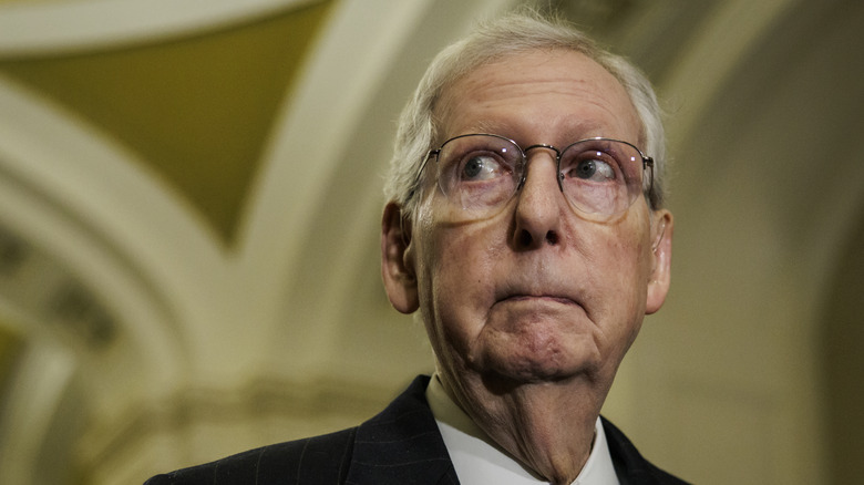 Mictch McConnell staring in close-up wire rim glasses