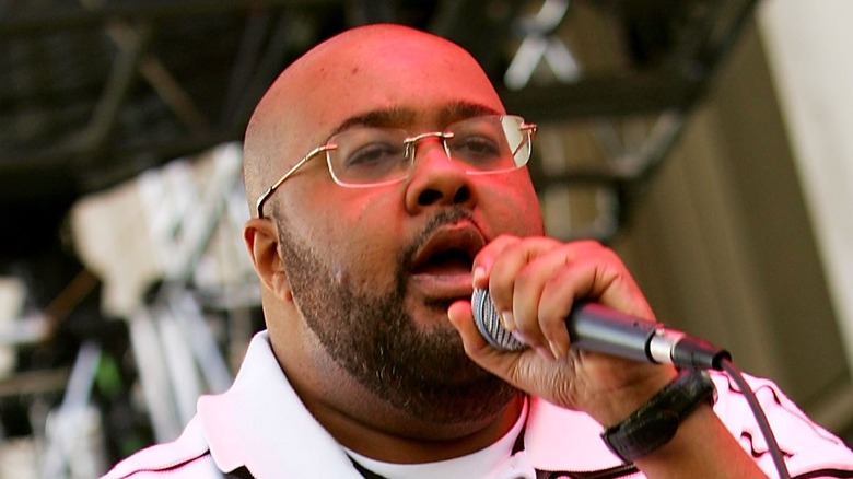 Gift of Gab, bald, with facial hair, performing on stage  in 2006