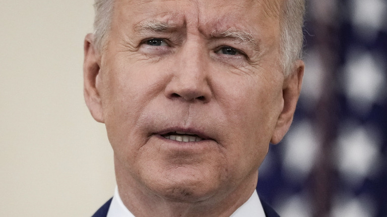 President Joe Biden speaking with serious expression