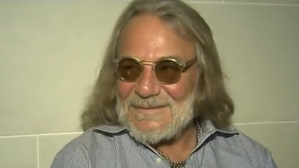 Dr. Harold Bornstein wearing shaded glasses and smiling to his right 