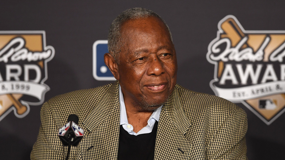 Hank Aaron smiling at a press conference
