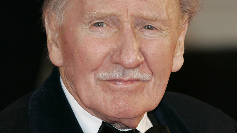 Leslie Phillips wearing a black tuxedo