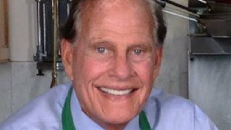Ron Popeil posing with one of his many products