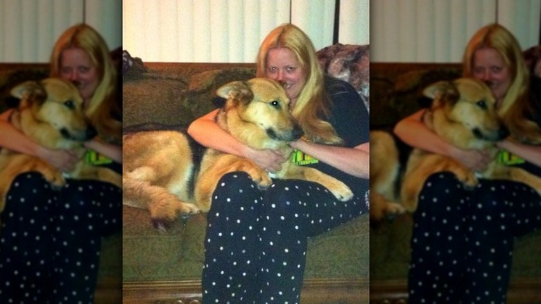Nancy Motes hugs dog 